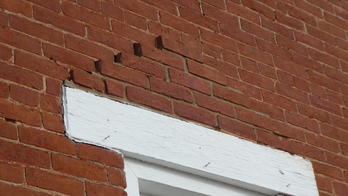 photo of bricks over the window of courthouse